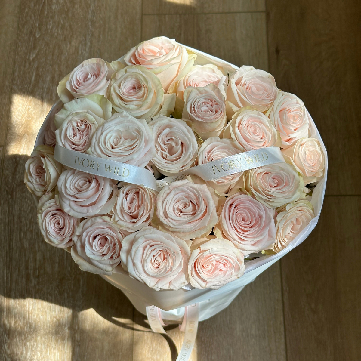 Large Soft Blush bouquet of pale blush and cream roses with branded ribbons by Ivory Wild, Austin florist.