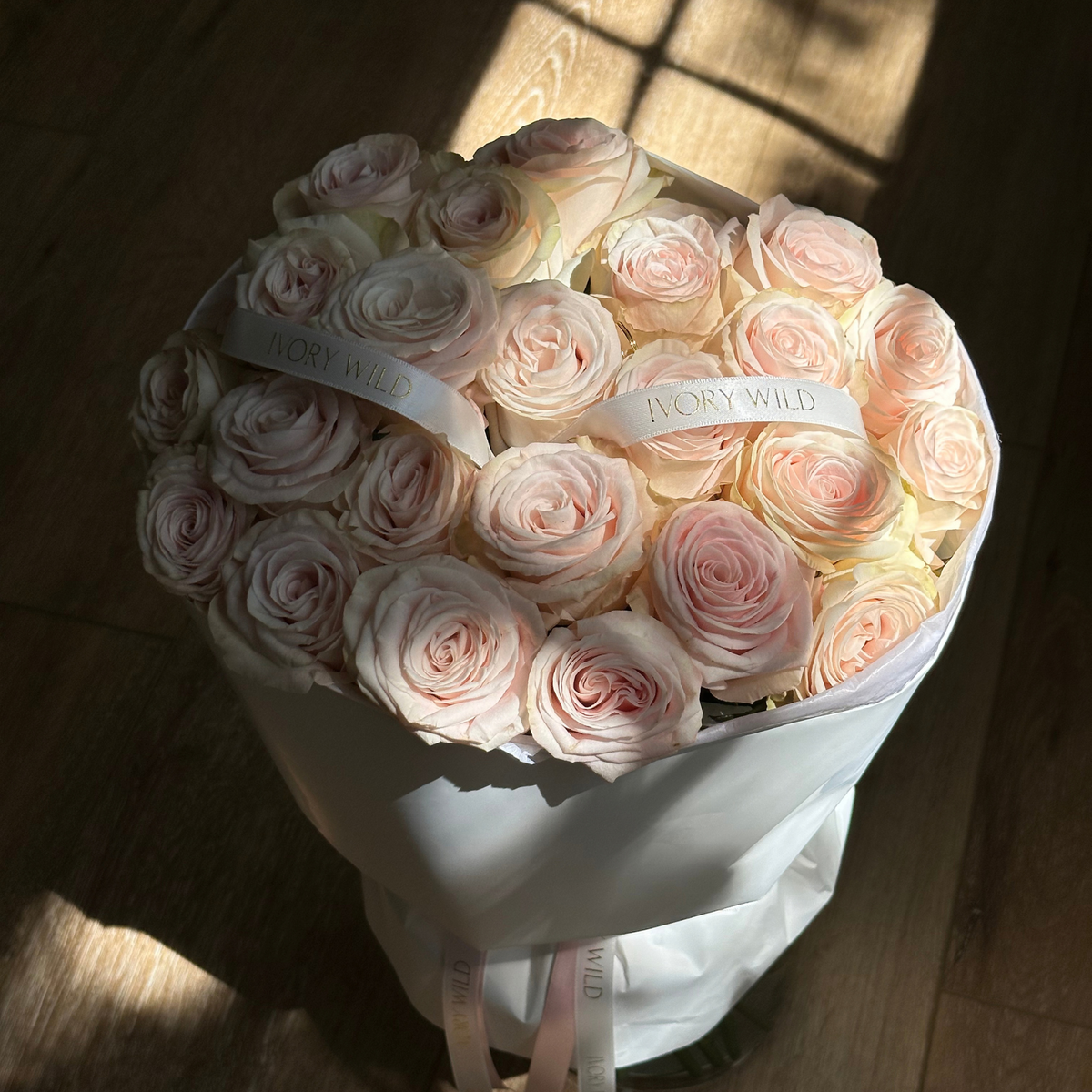 Large Soft Blush bouquet of pale blush and cream roses with branded ribbons by Ivory Wild, Austin florist.