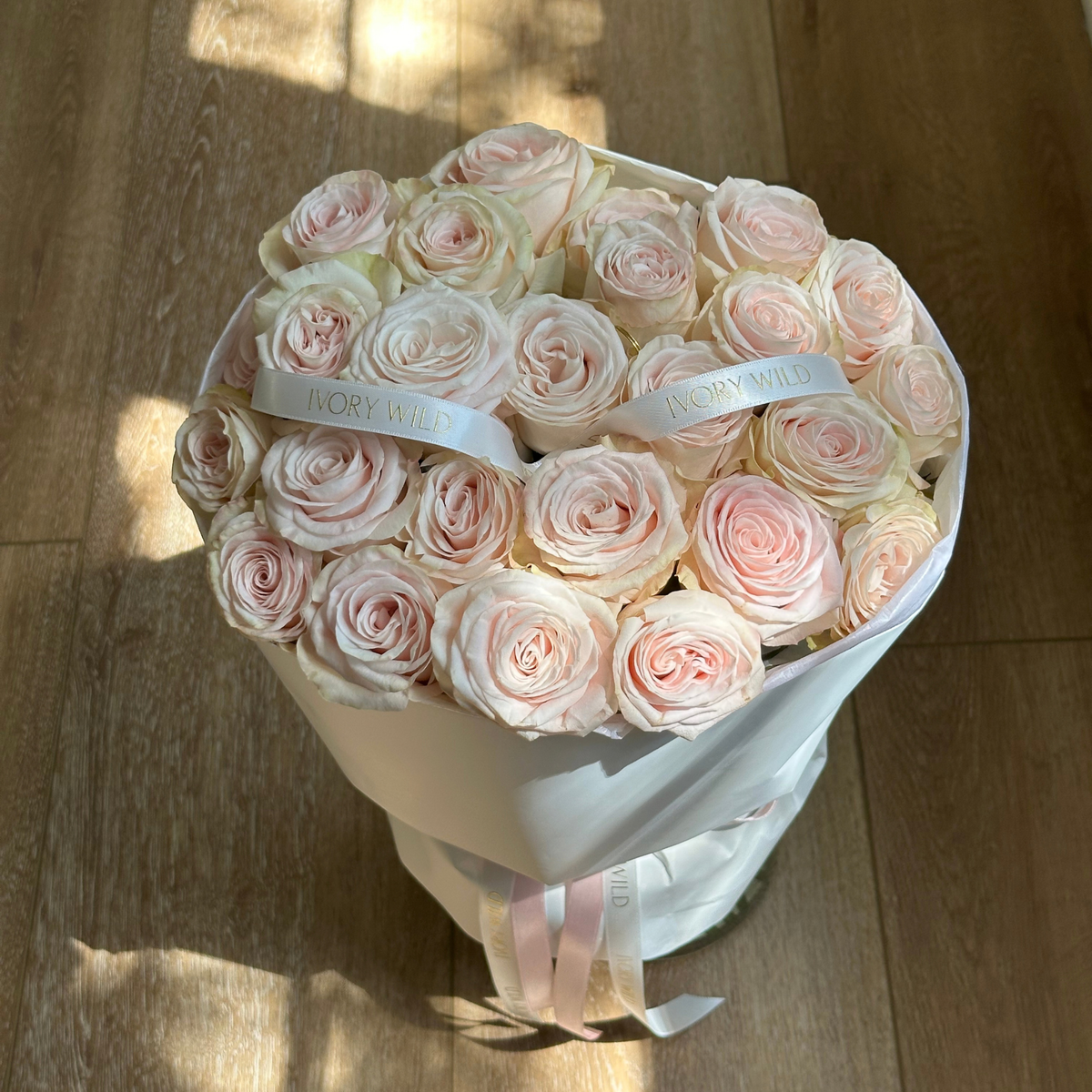 Large Soft Blush bouquet of pale blush and cream roses with branded ribbons by Ivory Wild, Austin florist.