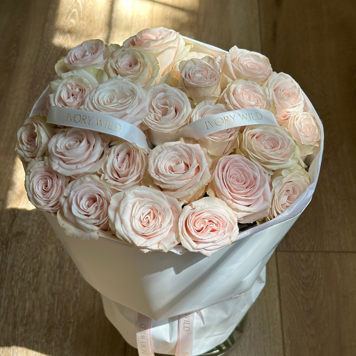 Large Soft Blush bouquet of pale blush and cream roses with branded ribbons by Ivory Wild, Austin florist.